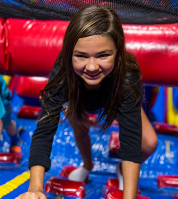 A girl at a field trip at a indoor playground with activities for kids