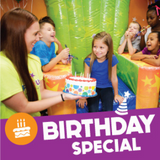 birthday special with birthday girl and party pro holding cake in front of birthday child