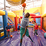 Bounce house with a basketball hoop for your birthday party
