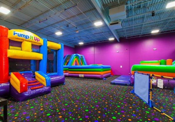 Pump It Up Arena space for kids birthday party filled with large inflatable attractions