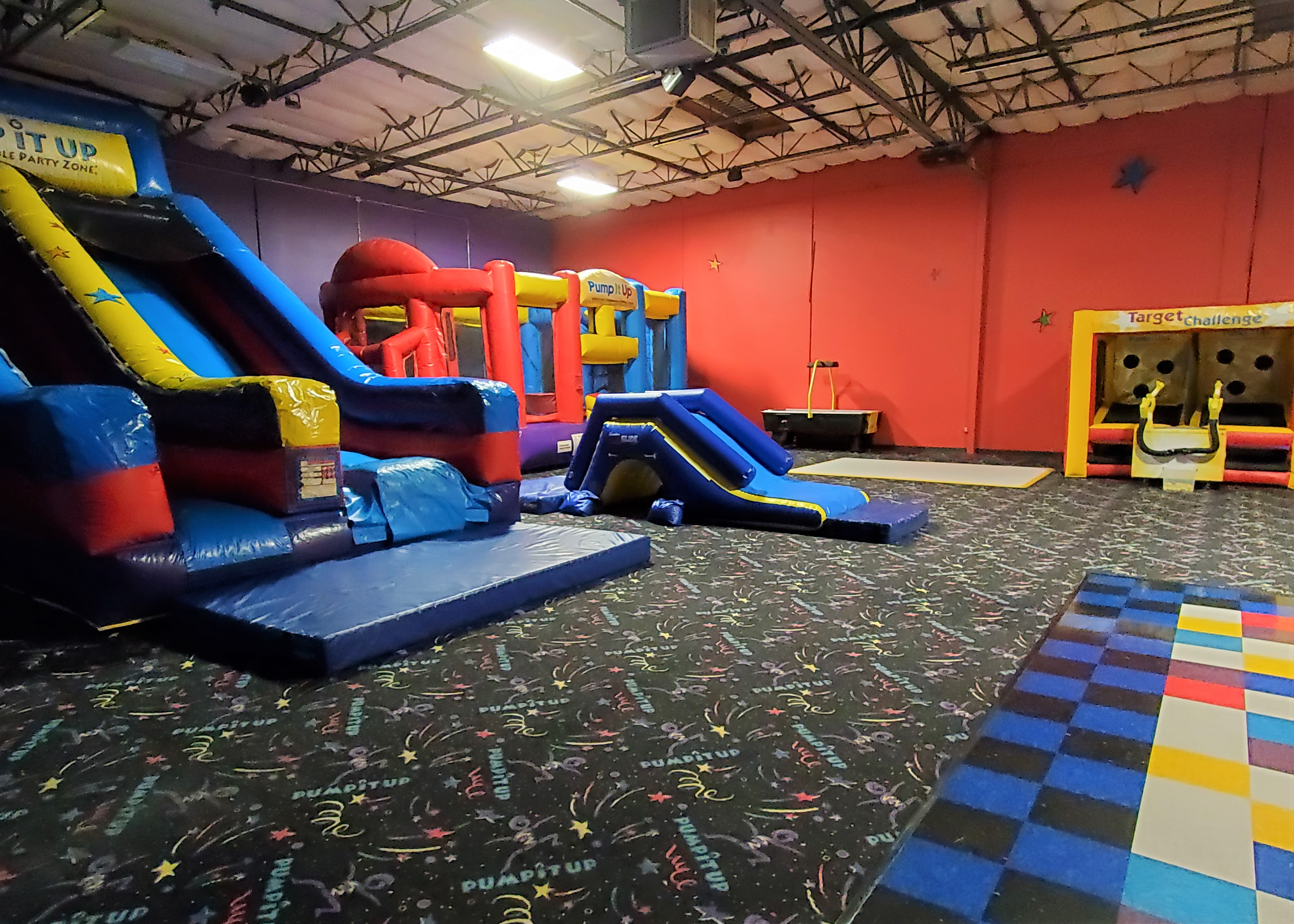 Pump It Up Oakland kids private birthday party indoor arena filled with inflatable attractions.