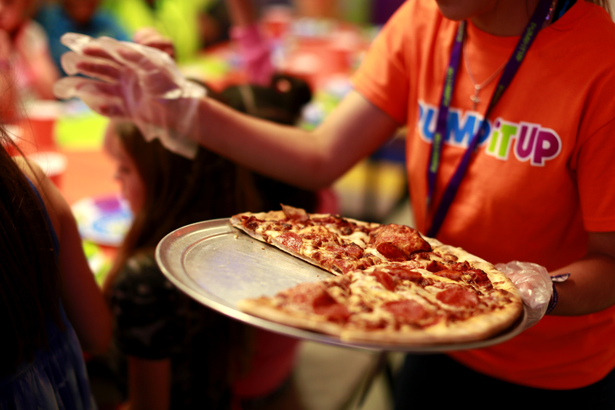 Pump it up staff handing out pizza