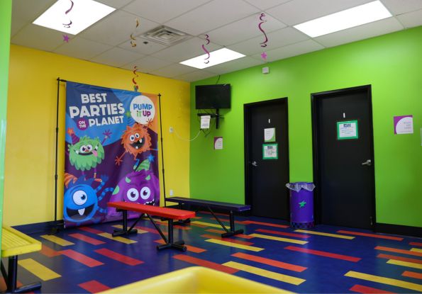 Pump It Up Bartlett TN lobby area and video area where 100% private birthday parties watch a safety video