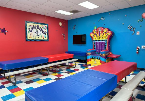 Pump It Up Oakland CA kids private birthday party place private party room with picnic tables and inflatable throne chair.