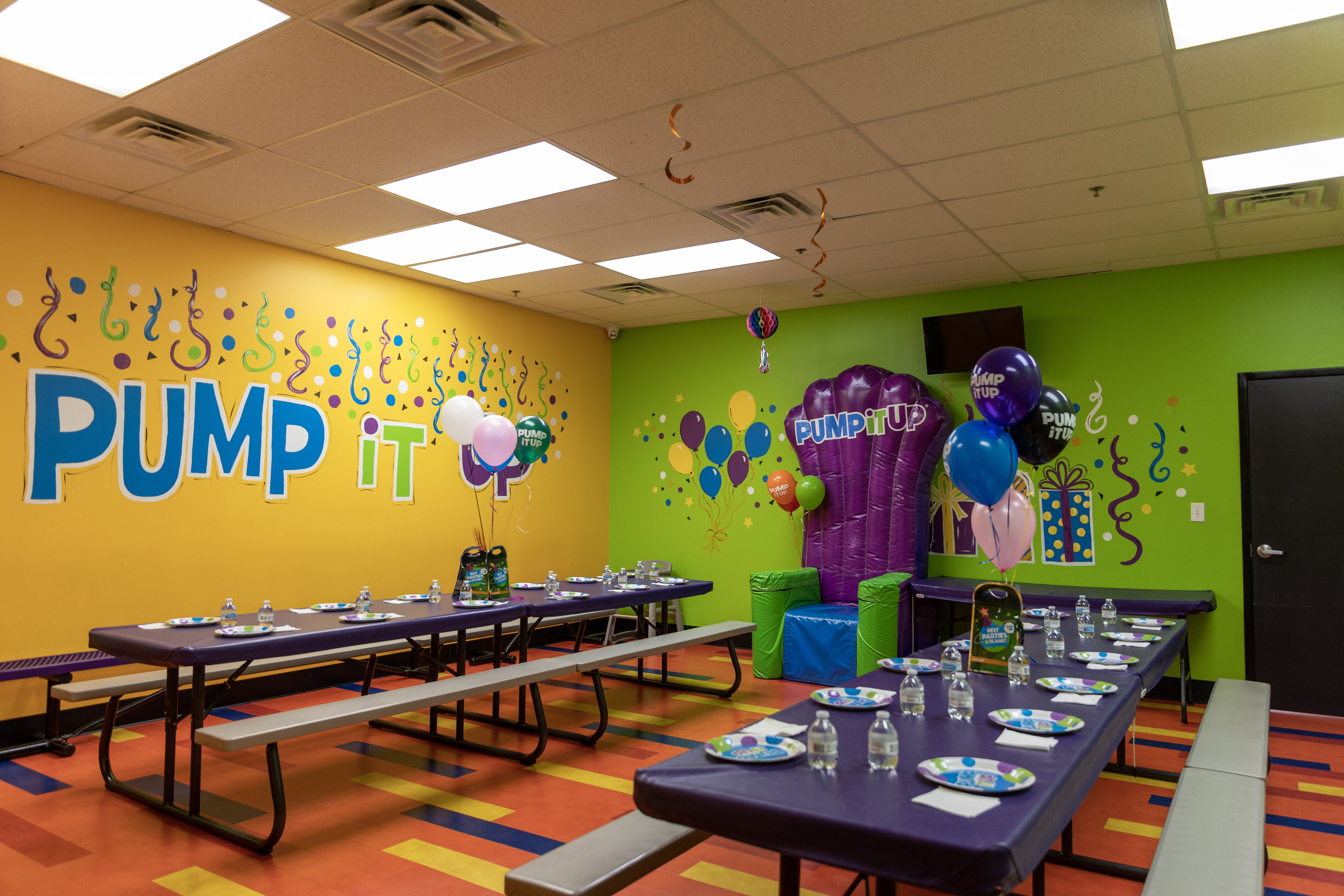 Pump It Up Bartlett TN private party room with tables and an inflatable throne for birthday child to sit on.
